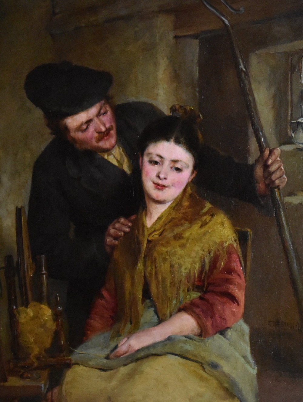 A 19th-century genre oil painting in an ornate gilt frame depicting a seated woman wearing a yellow shawl with a standing man behind her inside a rustic interior. View V