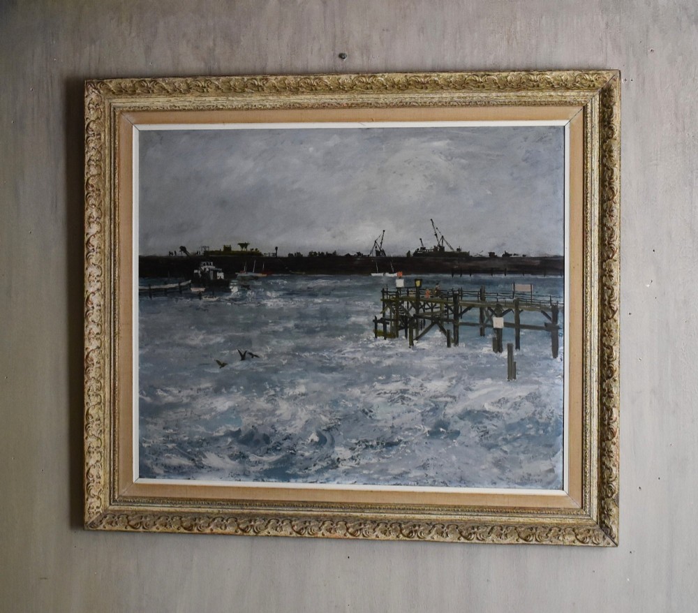 A framed oil painting depicting a grey and blue coastal harbour scene with choppy waters, a wooden pier, and ships on the horizon.