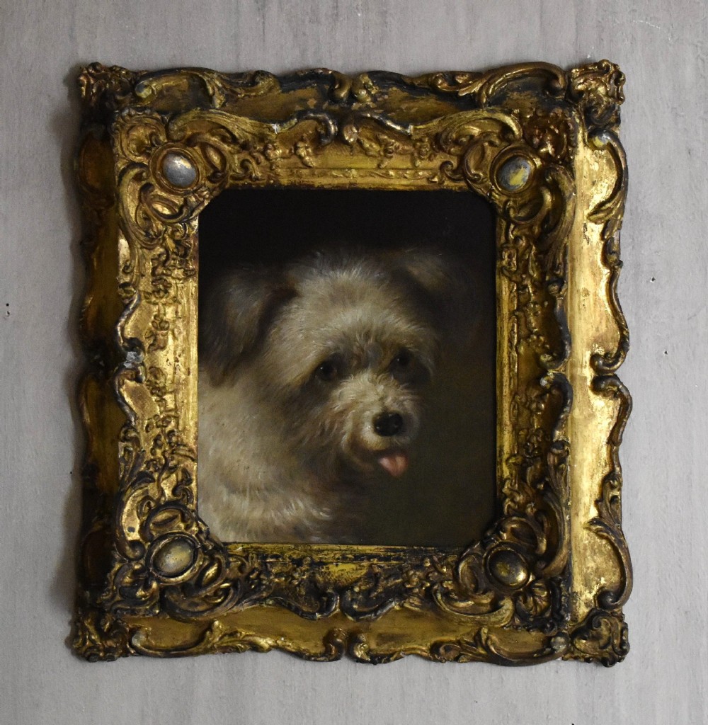 A 19th-century oil painting depicting a small terrier dog with its tongue slightly protruding, set within an ornate gilded frame. View II