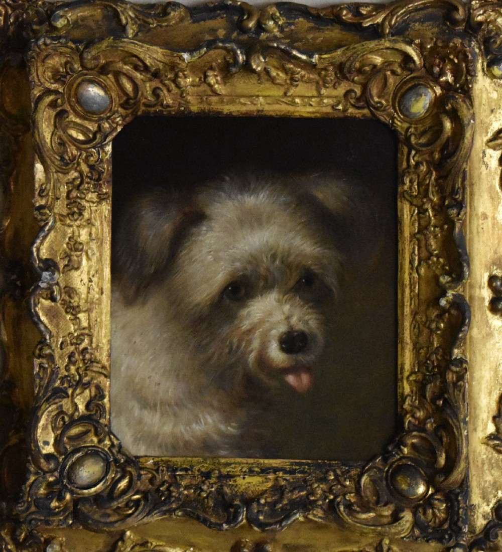 A 19th-century oil painting depicting a small terrier dog with its tongue slightly protruding, set within an ornate gilded frame. View III