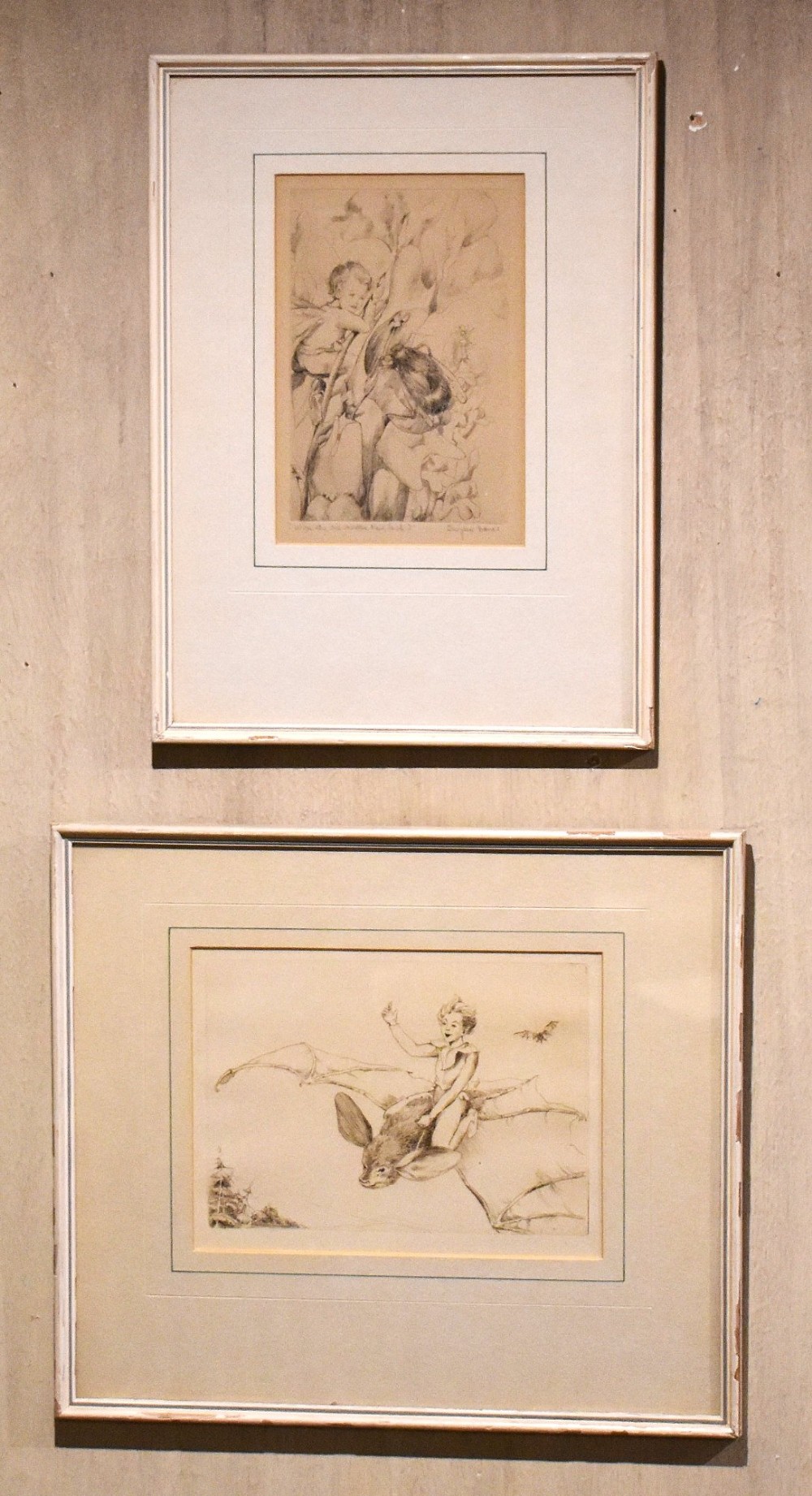 A pair of vertically stacked framed monochrome prints depicting illustrated scenes from Shakespeares The Tempest set within cream mounts and thin light frames. View II