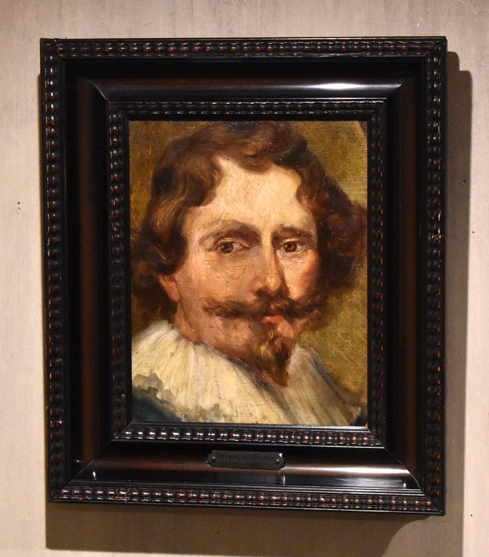 An oil painting portrait depicting a man with a moustache and white collar set within a dark moulded wood frame.
