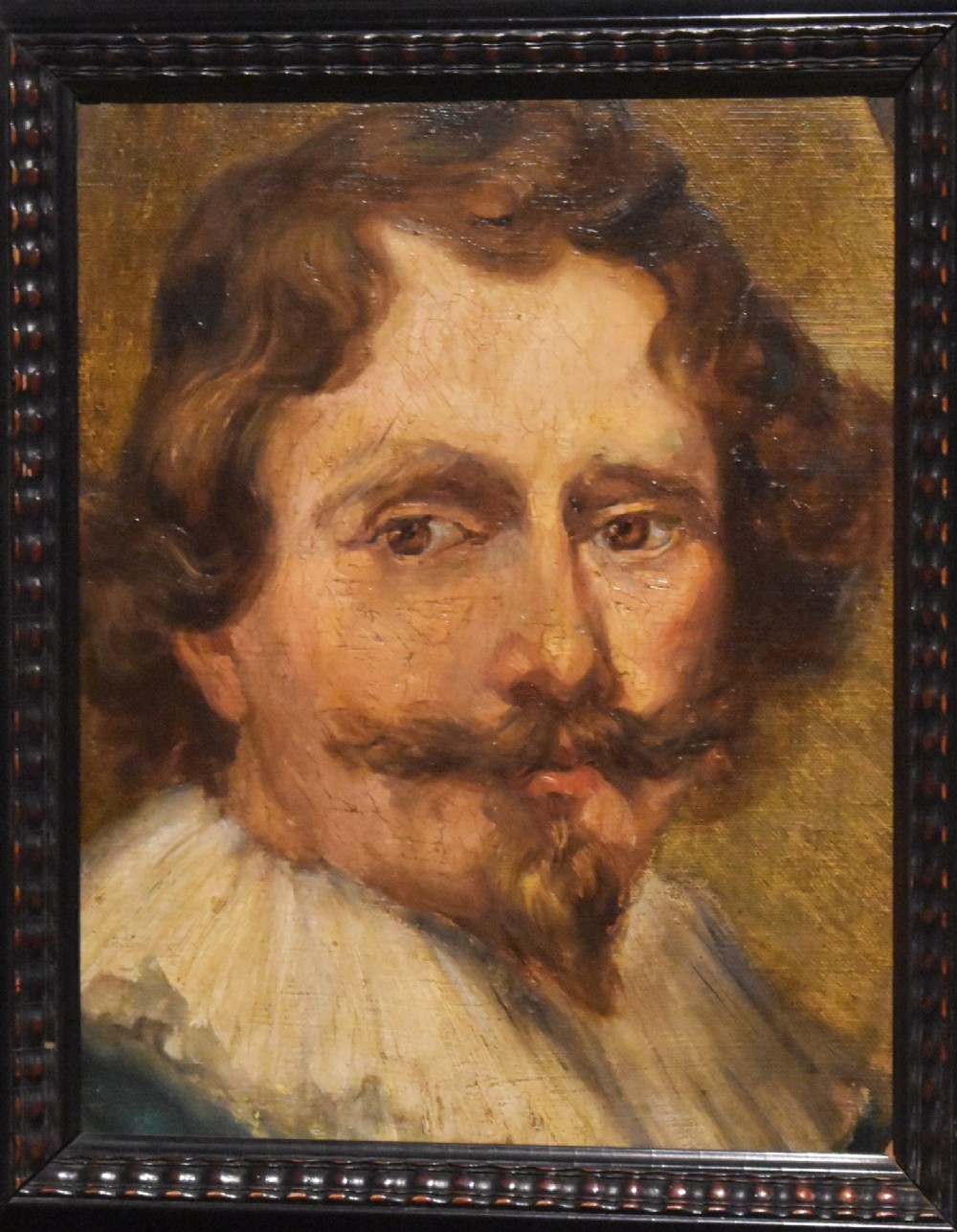 An oil painting portrait depicting a man with a moustache and white collar set within a dark moulded wood frame. View III