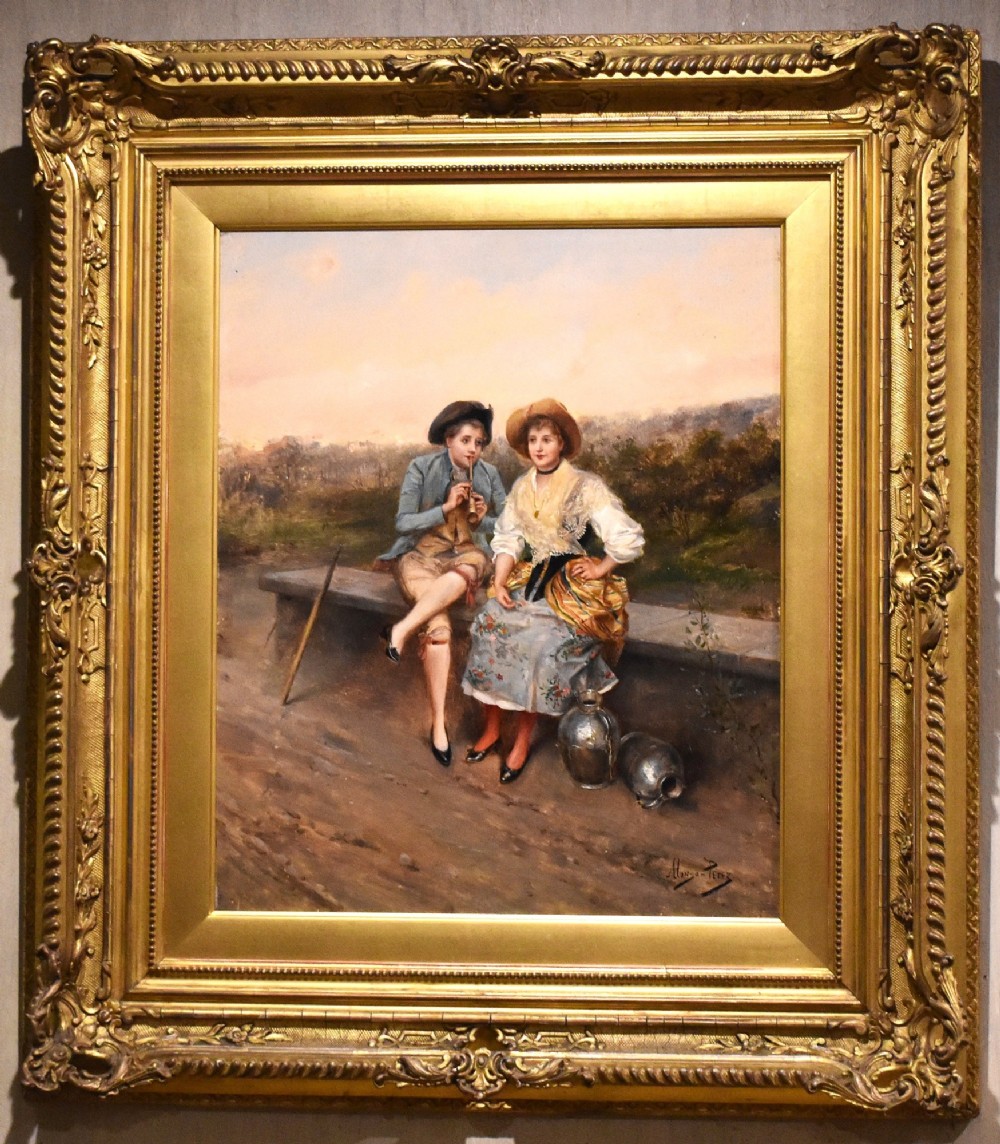 An oil painting depicting two figures in 18th-century costume seated outdoors, presented in a carved gilt wood frame. View II