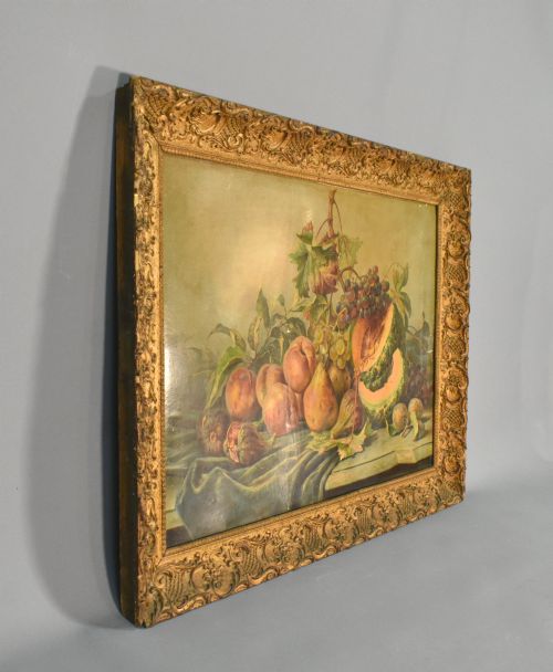 fig 1. A large rectangular Louis XV style giltwood frame with detailed carved foliage mouldings framing a still life fruit painting.