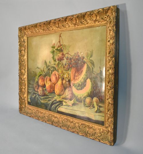 fig 2. A large rectangular Louis XV style giltwood frame with detailed carved foliage mouldings framing a still life fruit painting.