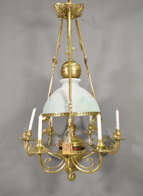 fig 1. A large French Napoleon III period bronze chandelier featuring a central domed opaline glass shade surrounded by multiple curved scroll arms with candle sconces.