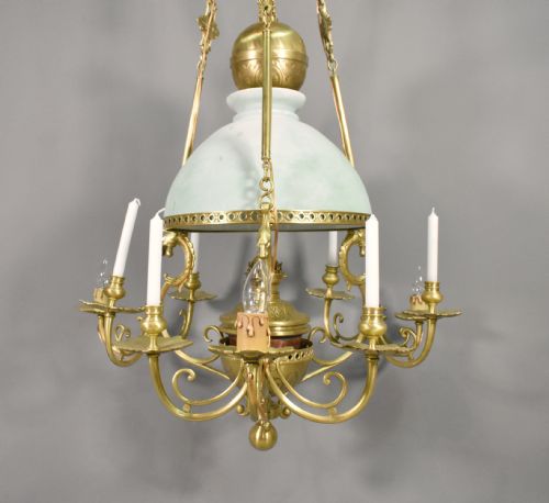 fig 3. A large French Napoleon III period bronze chandelier featuring a central domed opaline glass shade surrounded by multiple curved scroll arms with candle sconces.