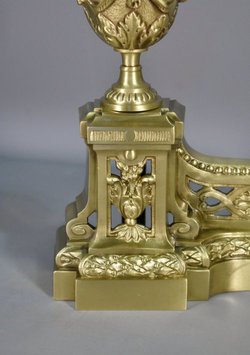 fig 2. A pair of nineteenth-century French bronze fire dogs featuring carved urn finials, draped swags, and openwork bases.