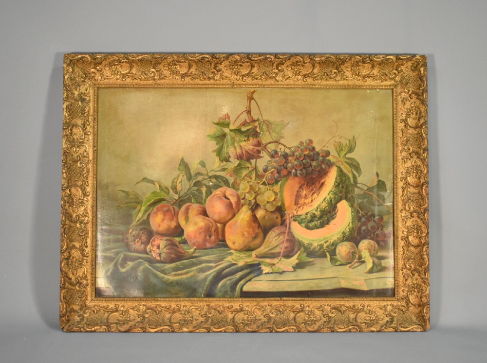 A large rectangular Louis XV style giltwood frame with detailed carved foliage mouldings framing a still life fruit painting.