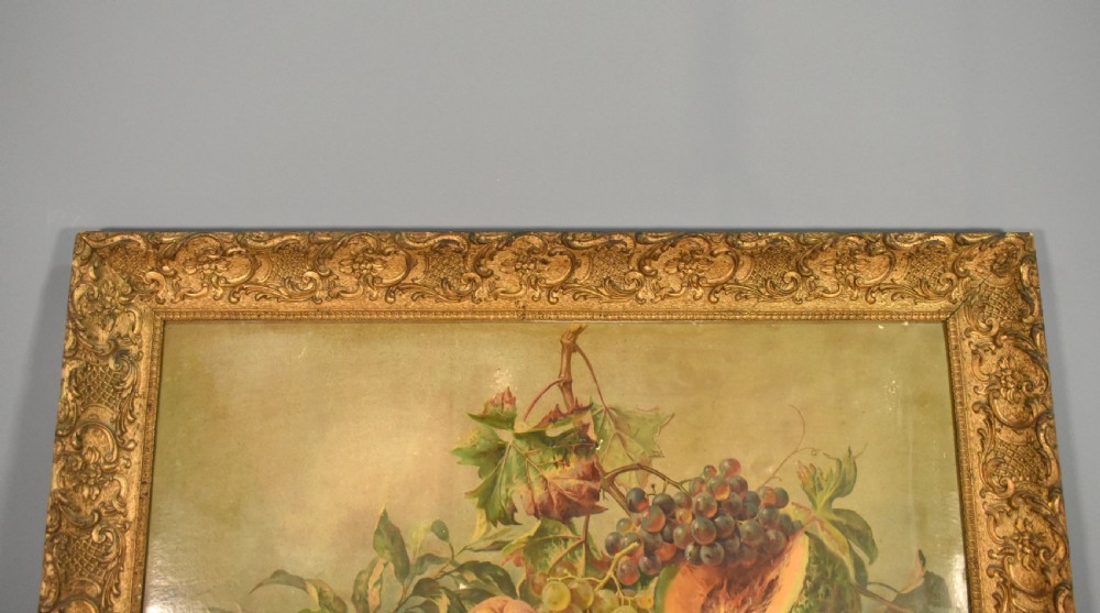 A large rectangular Louis XV style giltwood frame with detailed carved foliage mouldings framing a still life fruit painting. View IV