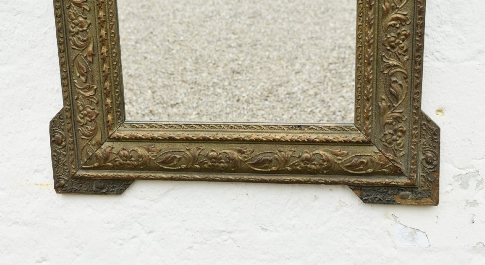 A rectangular antique French Napoleon III giltwood wall mirror with an ornate carved floral frame and top acanthus crest. View VIII