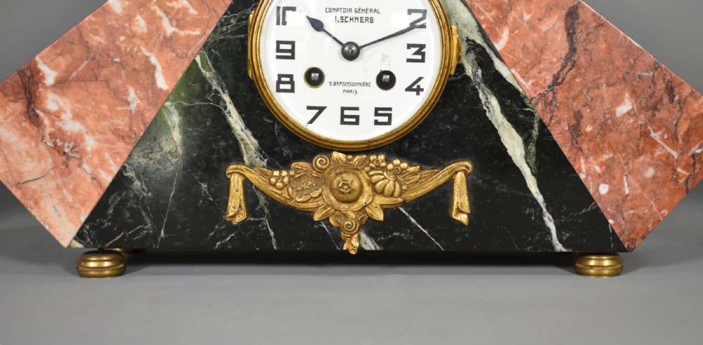 A French Art Deco three-piece clock set made from geometric pink and black veined marble with brass mounts. View VIII