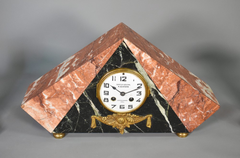 A French Art Deco three-piece clock set made from geometric pink and black veined marble with brass mounts. View IX