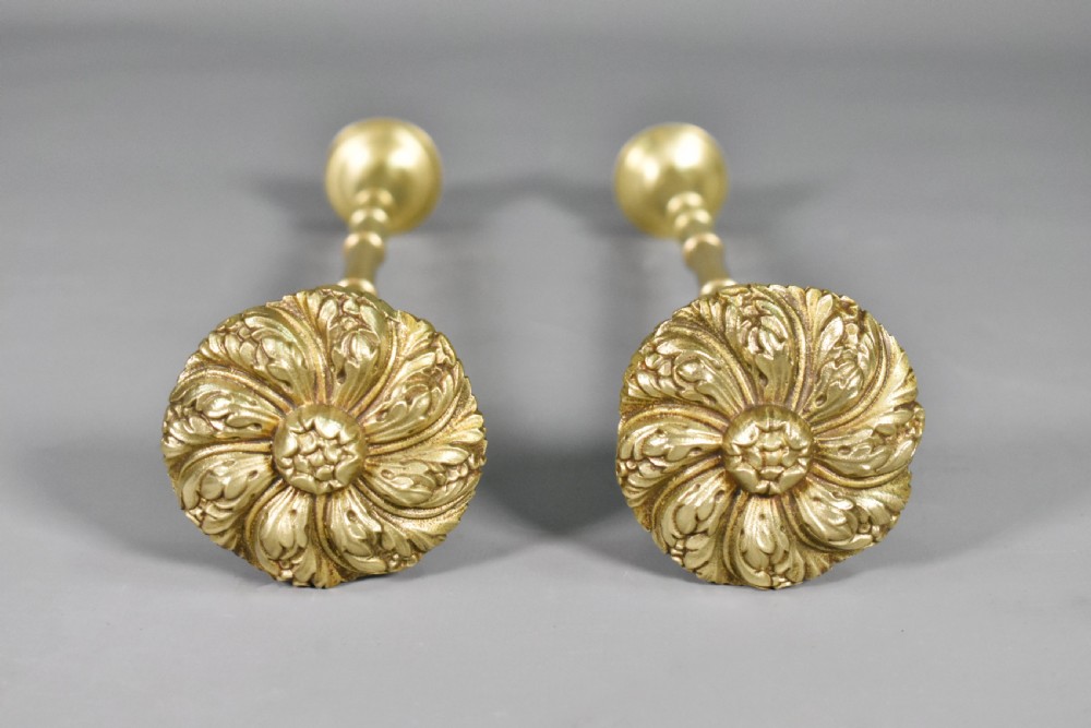 A pair of Second Empire French brass curtain tie-backs featuring circular carved floral rosettes on extended stems. View VII