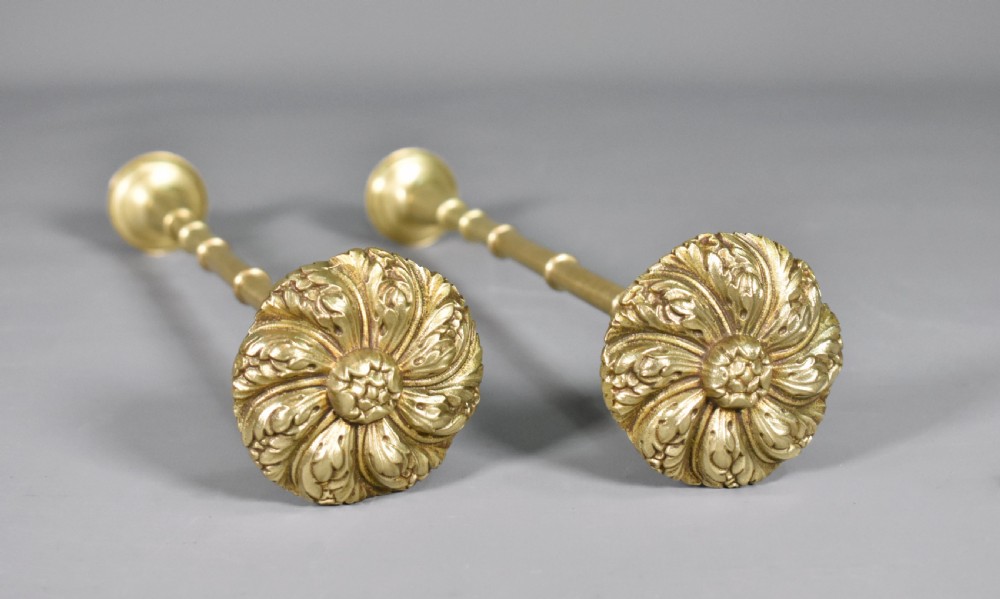 A pair of Second Empire French brass curtain tie-backs featuring circular carved floral rosettes on extended stems. View VIII