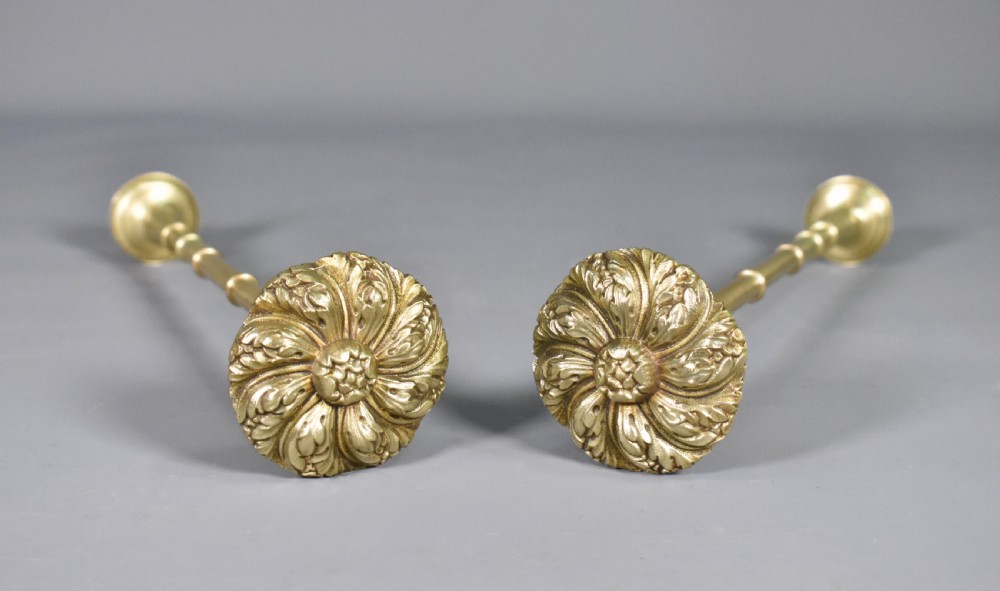 A pair of Second Empire French brass curtain tie-backs featuring circular carved floral rosettes on extended stems. View IX