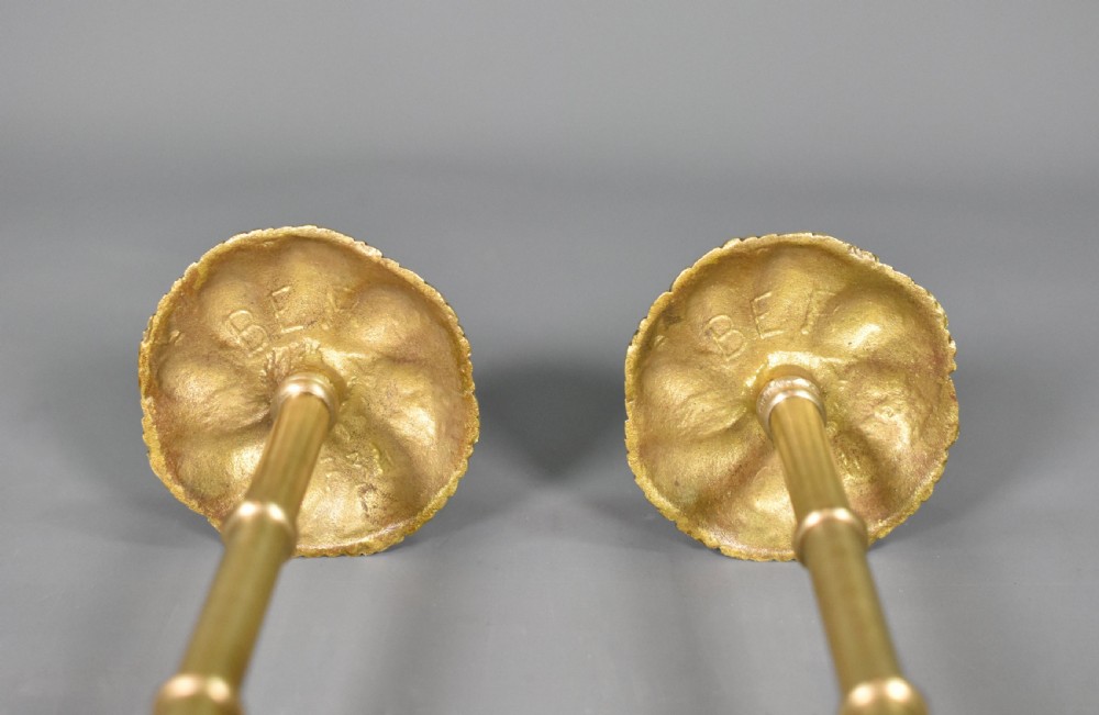 A pair of Second Empire French brass curtain tie-backs featuring circular carved floral rosettes on extended stems. View XV