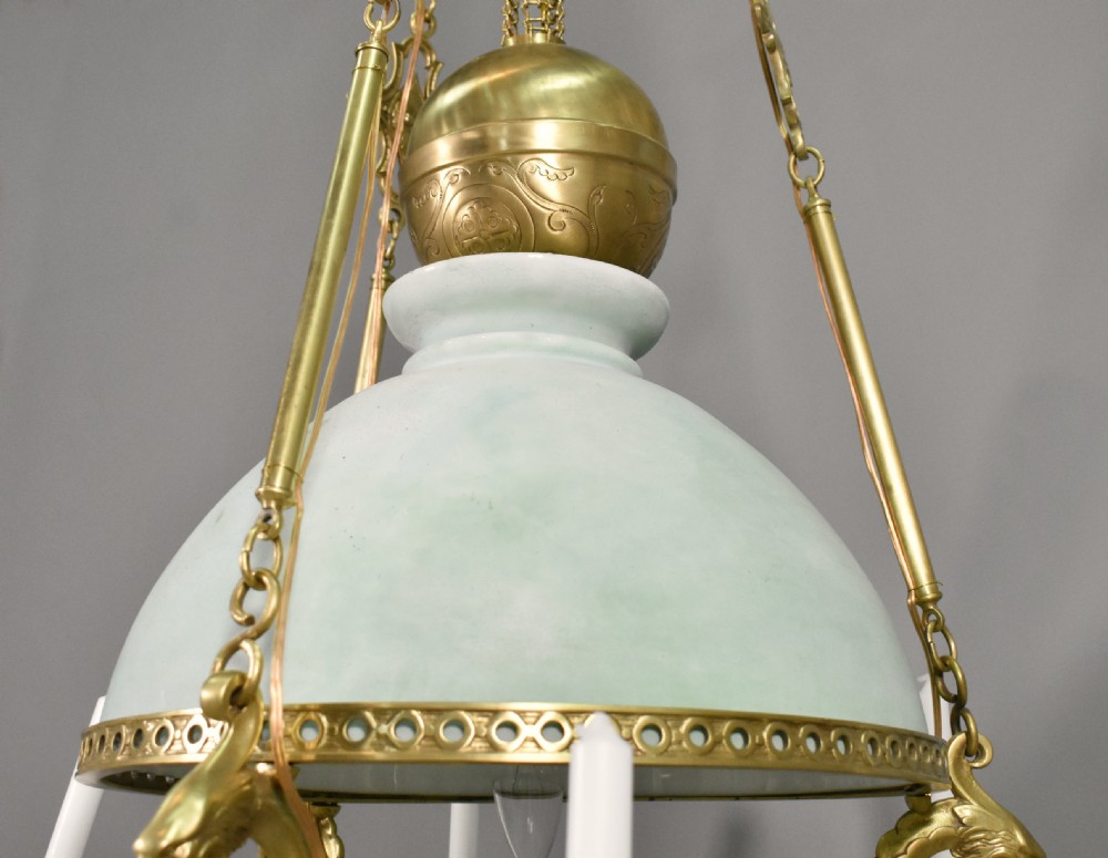 A large French Napoleon III period bronze chandelier featuring a central domed opaline glass shade surrounded by multiple curved scroll arms with candle sconces. View VII