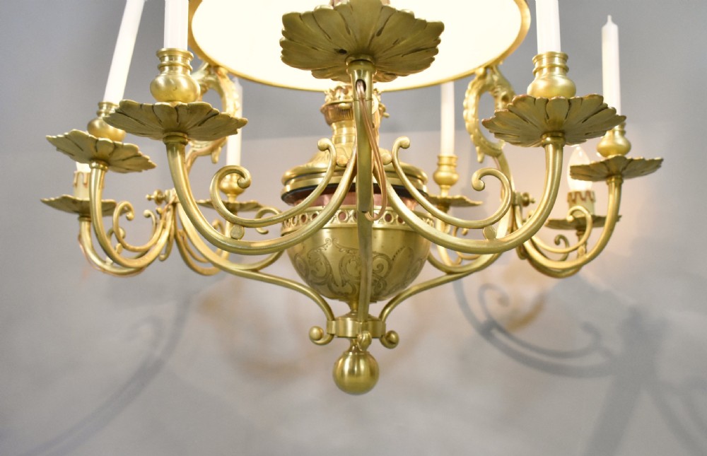 A large French Napoleon III period bronze chandelier featuring a central domed opaline glass shade surrounded by multiple curved scroll arms with candle sconces. View XII