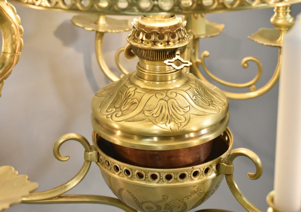 A large French Napoleon III period bronze chandelier featuring a central domed opaline glass shade surrounded by multiple curved scroll arms with candle sconces. View XVIII