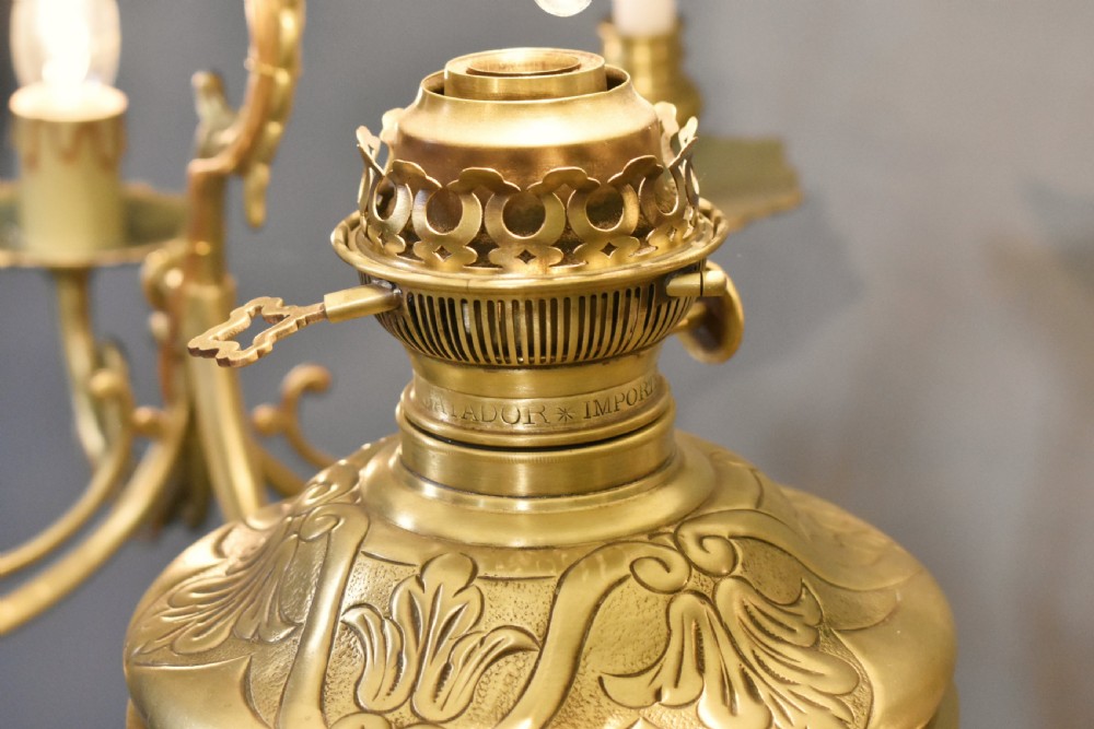 A large French Napoleon III period bronze chandelier featuring a central domed opaline glass shade surrounded by multiple curved scroll arms with candle sconces. View XX