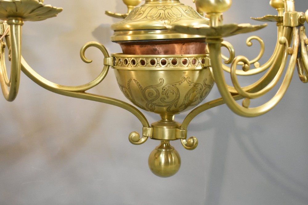 A large French Napoleon III period bronze chandelier featuring a central domed opaline glass shade surrounded by multiple curved scroll arms with candle sconces. View XXI