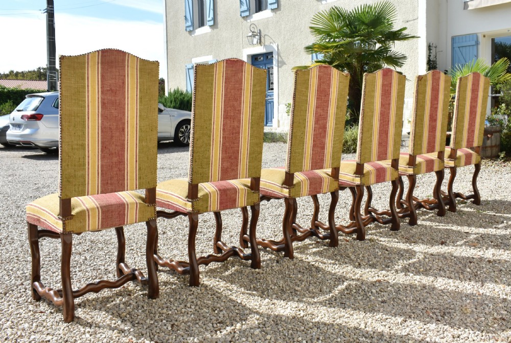 A set of six French Louis XIII style oak dining chairs featuring carved os de mouton legs and striped terracotta red and olive green upholstery. View IX