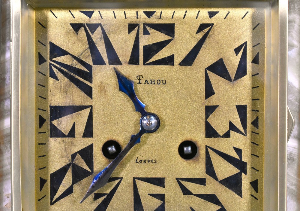 A three-piece French Art Deco clock garniture set featuring a central geometric onyx and marble clock topped with a bronze-finished figure of a female with birds, accompanied by two matching side pedestals. View X