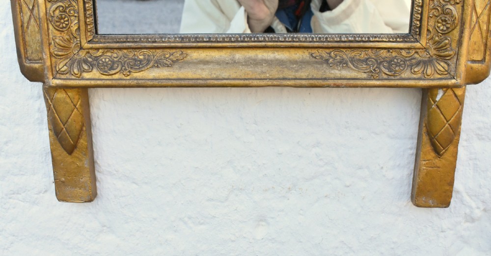 A rectangular French giltwood wall mirror featuring carved floral cresting and a gold leaf frame. View IX