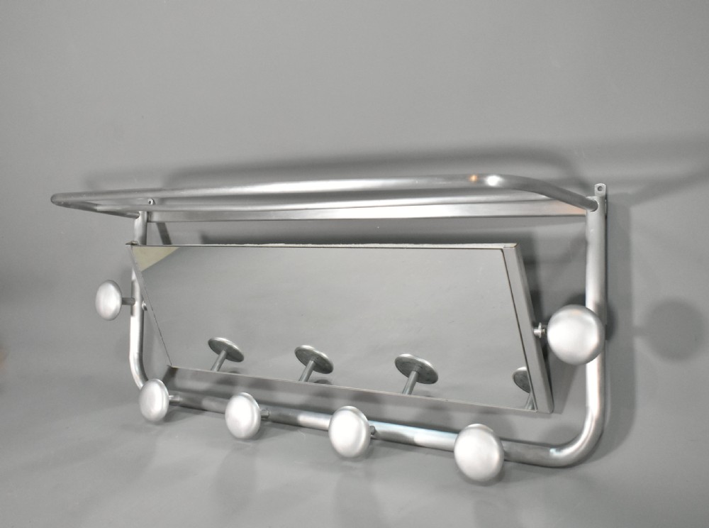 A French Art Deco wall-mounted tubular aluminium coat and hat rack featuring a central rectangular mirror, top slatted shelf, and spherical pegs. View III