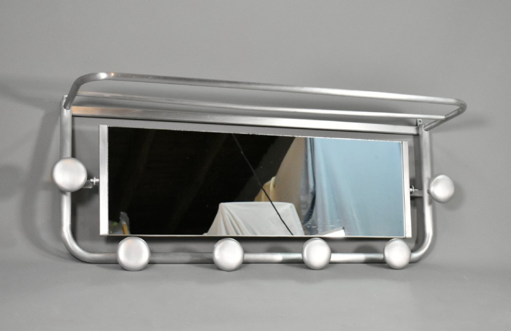 A French Art Deco wall-mounted tubular aluminium coat and hat rack featuring a central rectangular mirror, top slatted shelf, and spherical pegs. View V