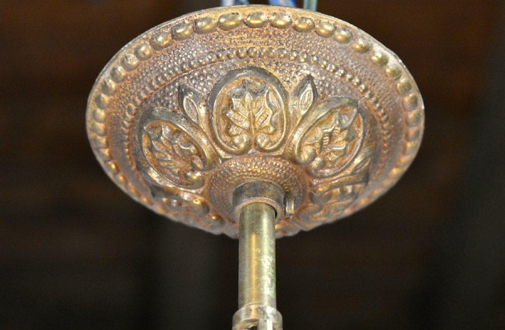 A cylindrical glass hall lantern featuring starburst engravings, gilt brass acanthus leaf mounts, and an interior multi-candle bulb holder. View VI
