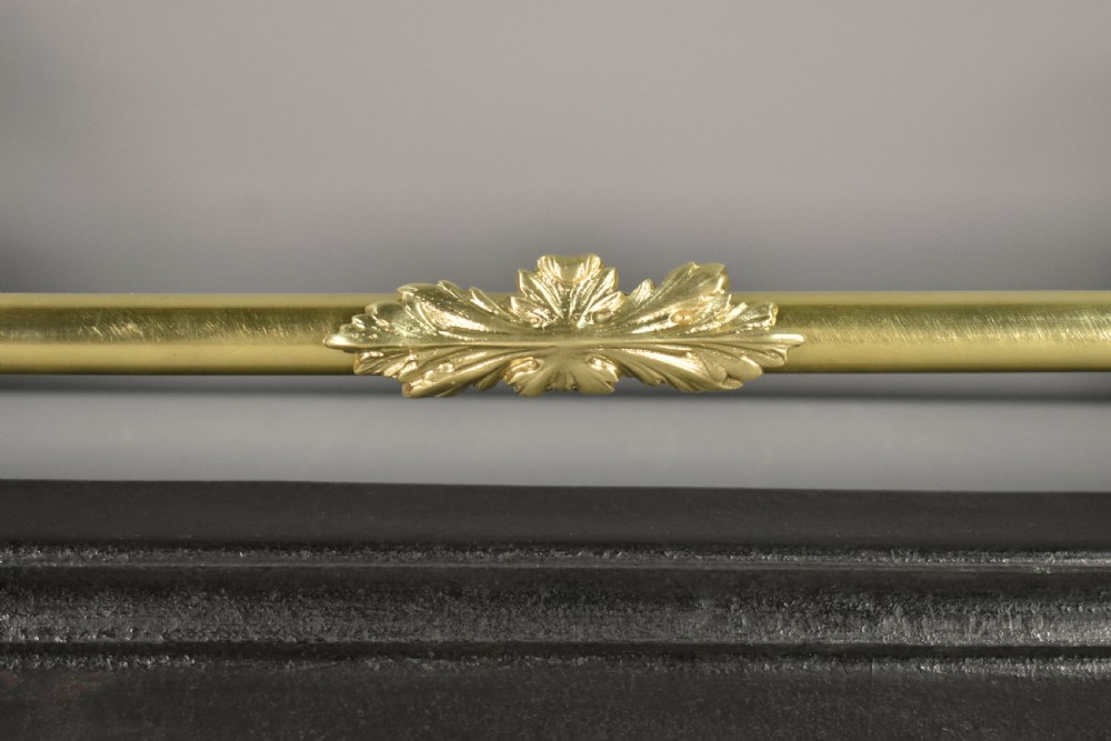 A 19th-century French fireplace fender featuring dark patinated metal greyhound sculptures resting on bases on either side of a polished brass rail with central gold-toned foliate detailing. View V