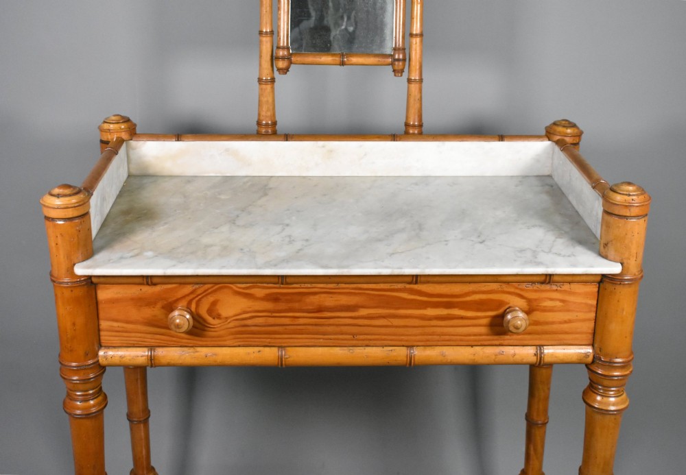 An antique French Napoleon III style washstand with a turned pine faux bamboo frame, marble top, lower shelf, and attached tilting mirror. View IV