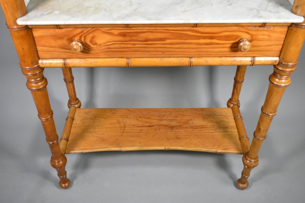 An antique French Napoleon III style washstand with a turned pine faux bamboo frame, marble top, lower shelf, and attached tilting mirror. View VIII