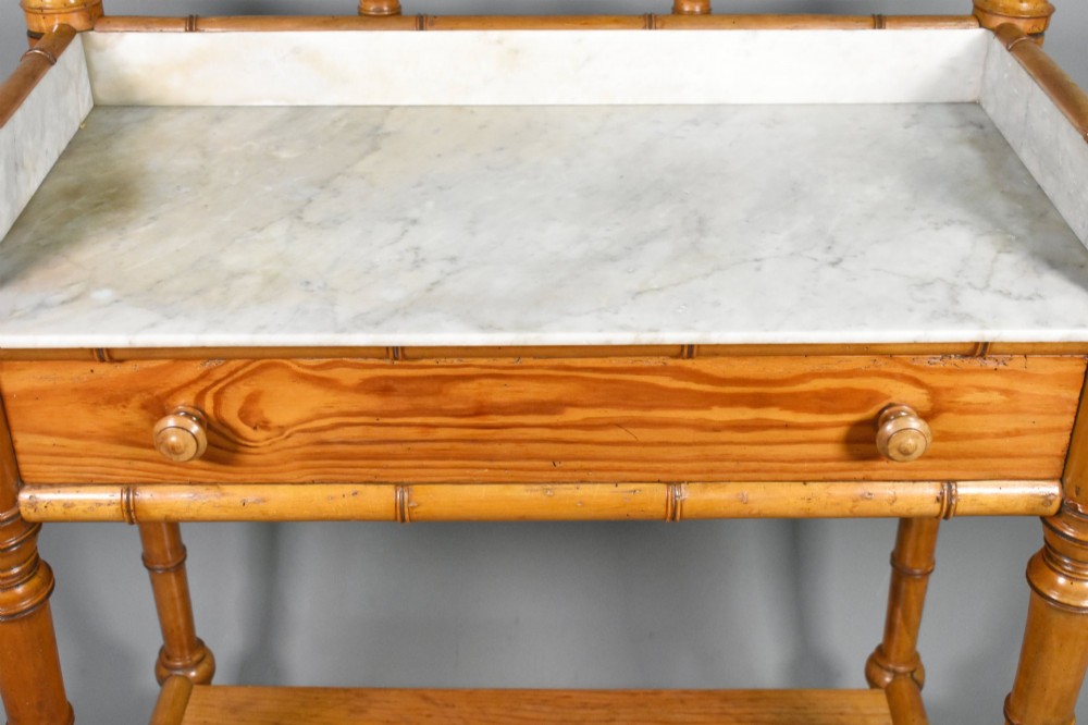 An antique French Napoleon III style washstand with a turned pine faux bamboo frame, marble top, lower shelf, and attached tilting mirror. View IX