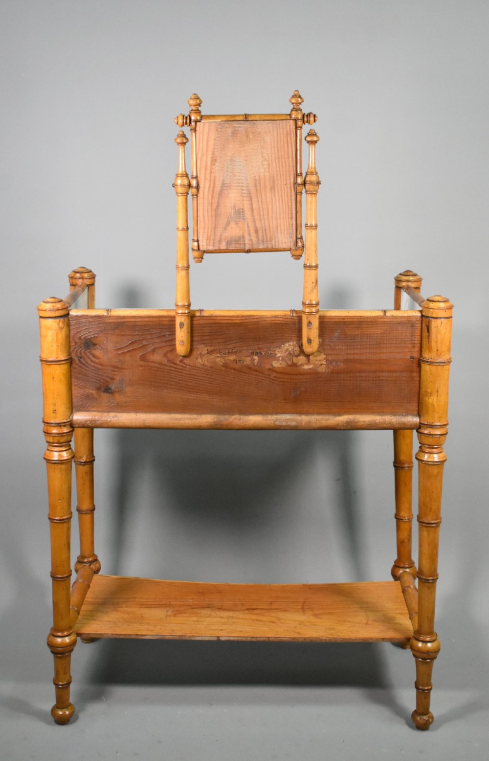 An antique French Napoleon III style washstand with a turned pine faux bamboo frame, marble top, lower shelf, and attached tilting mirror. View XIII