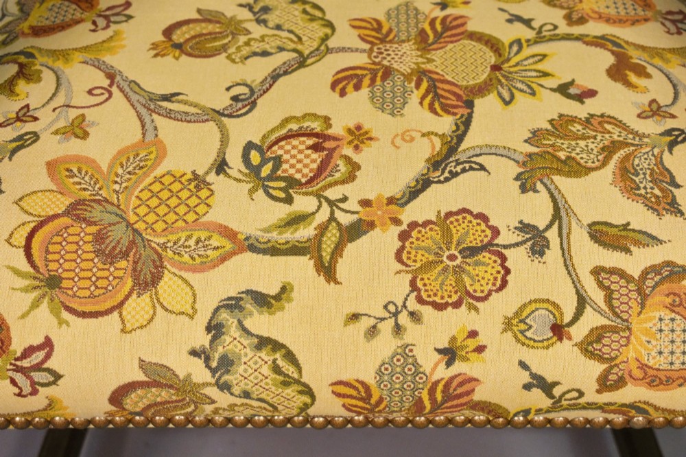 A French Renaissance Revival walnut armchair featuring yellow floral upholstery, brass stud trim, turned legs, spherical armrests, and a spindle gallery backrest. View XII
