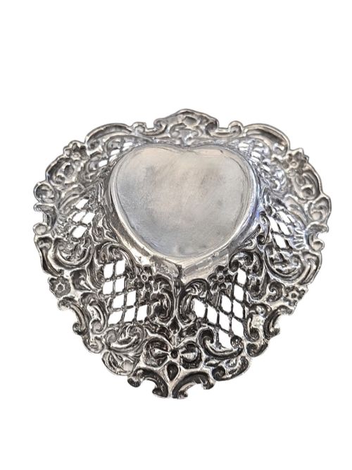 fig 1. An Edwardian sterling silver heart-shaped bonbon dish featuring an ornate pierced lattice border with scrollwork and a smooth central reservoir.