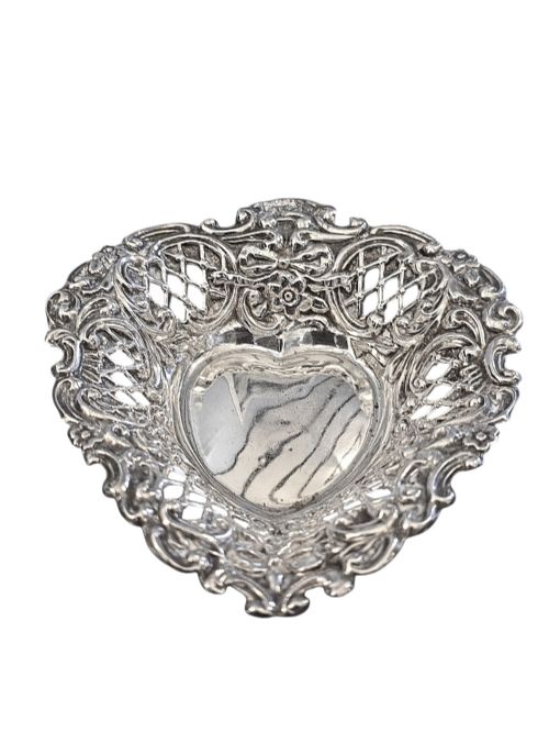 fig 2. An Edwardian sterling silver heart-shaped bonbon dish featuring an ornate pierced lattice border with scrollwork and a smooth central reservoir.