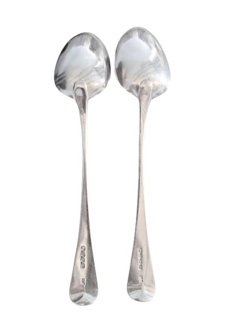 fig 1. A pair of 1789 Georgian sterling silver serving spoons with oval bowls, long stems, and hand-engraved terminals.