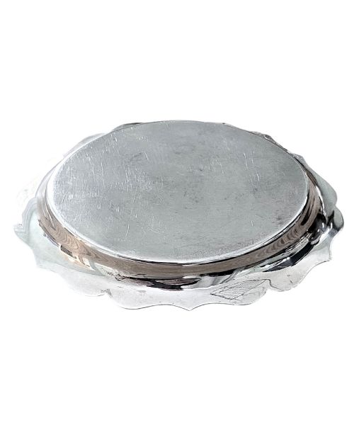 fig 1. A small sterling silver card tray featuring a scalloped border and stamped British hallmarks on the flat surface.