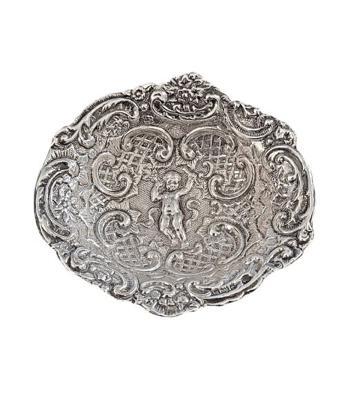 fig 2. An antique oval sterling silver bonbon dish featuring embossed scrollwork, lattice detailing, a central cherub figure, and spherical ball feet.