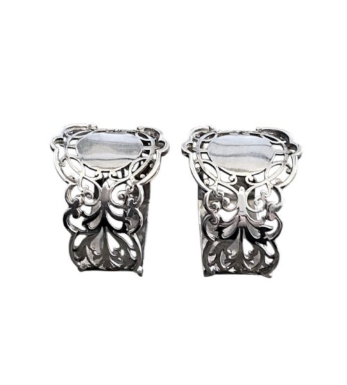 fig 2. A pair of Edwardian pierced sterling silver napkin rings with unengraved cartouches presented in a dark velvet-lined fitted box.