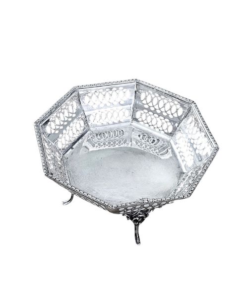 fig 1. An octagonal sterling silver bonbon dish featuring pierced fretwork sides and three splayed scroll feet.