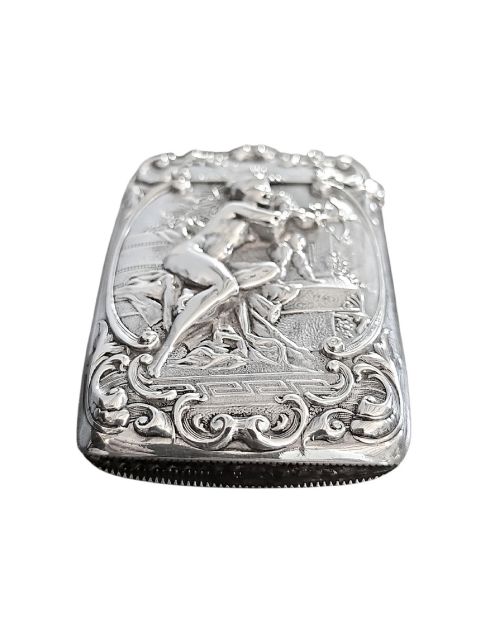 fig 3. An Edwardian sterling silver vesta case featuring embossed relief detailing of Cupid and Psyche framed by scrollwork borders.