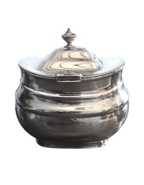 fig 2. An Edwardian sterling silver tea caddy featuring a bulbous body, stepped lid, and urn-shaped finial.