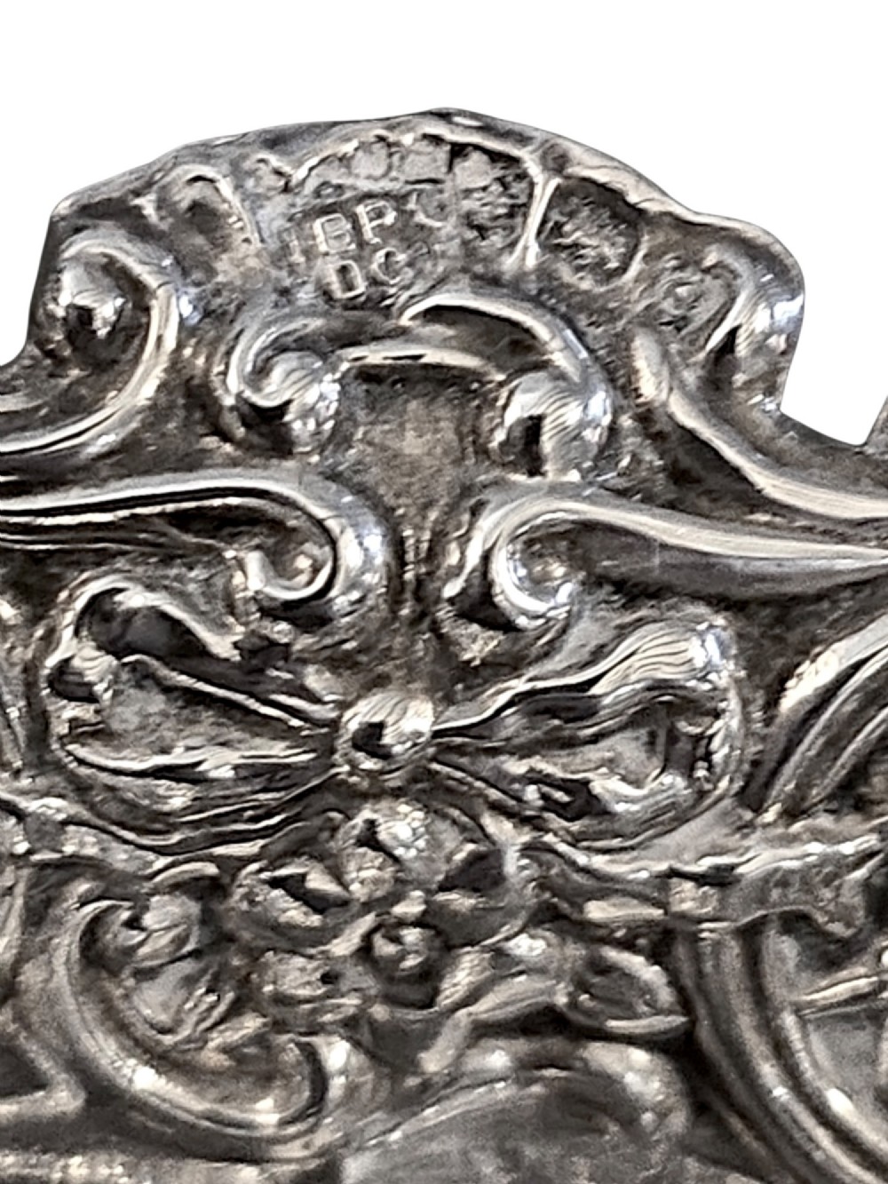 An Edwardian sterling silver heart-shaped bonbon dish featuring an ornate pierced lattice border with scrollwork and a smooth central reservoir. View IV