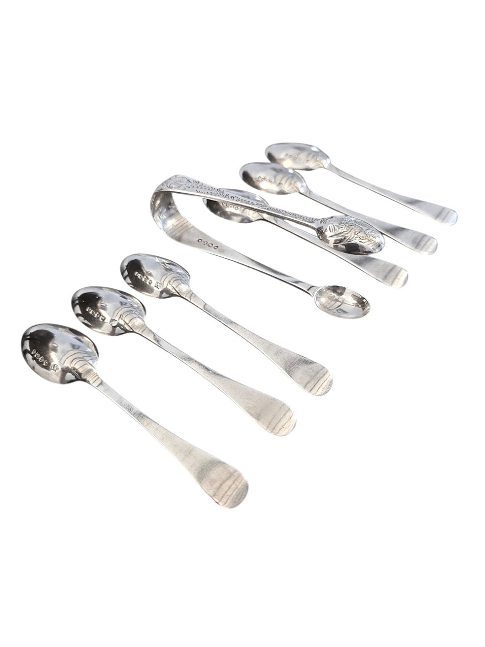 Set of six Victorian sterling silver teaspoons and matching sugar tongs featuring engraved bird and foliate motifs. View II